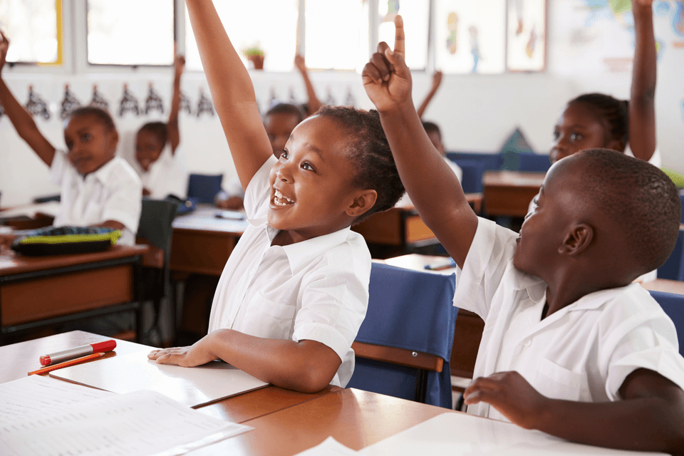 A student raising her hand in class